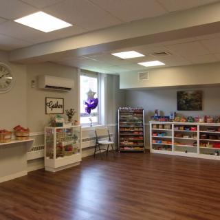 A spacious children's playroom with shelves of toys and games.