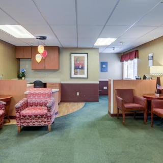 A welcoming office reception area with comfortable seating and warm decor.