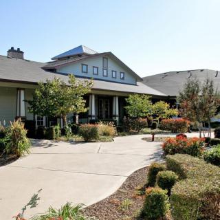 A well-landscaped front yard leading to a charming house.