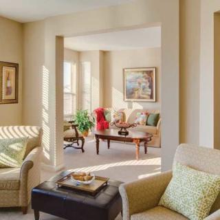 A cozy and well-lit living room with comfortable seating and elegant decor.