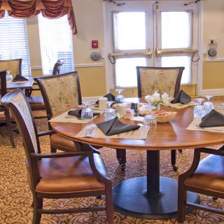 An elegantly set dining table in a cozy restaurant interior.