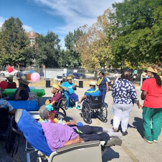 Seniors enjoying a community gathering at the park on a beautiful autumn day.