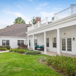 A beautiful house with a spacious lawn and garden area.