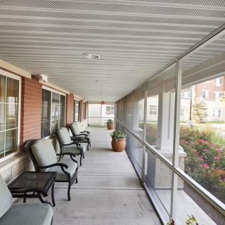 A cozy outdoor patio with comfortable seating and potted plants.