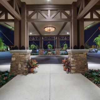 Elegant entrance with stone columns and night lighting.