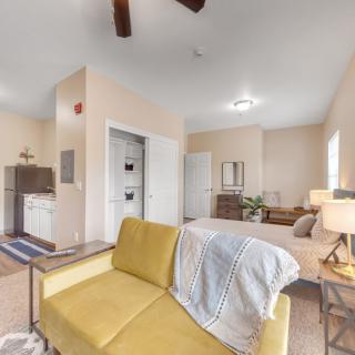 A cozy studio apartment with an open layout featuring a combined living, kitchen, and sleeping area.