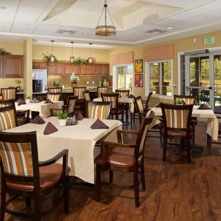 A cozy restaurant interior with neatly arranged tables and chairs, ready for guests.