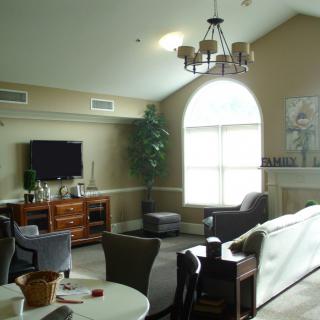 A cozy living room with modern furniture and a large window allowing natural light.