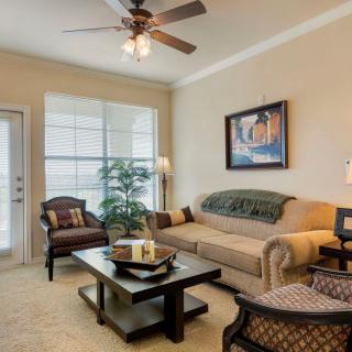 A cozy living room with a beige sofa, coffee table, and decorative elements.