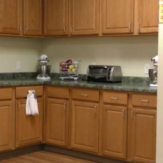 A kitchen with wooden cabinets and appliances on the countertop.