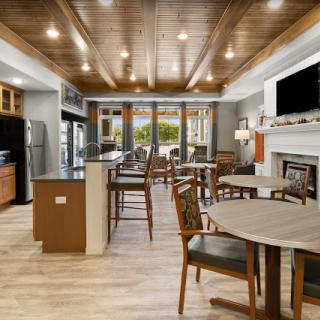 A modern kitchen and dining area with wooden ceilings and stylish furniture.