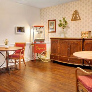 A vintage-style dining area with a popcorn machine and wooden furniture.