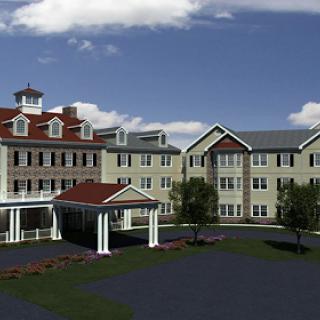 A modern residential building featuring a mix of architectural styles under a clear blue sky.