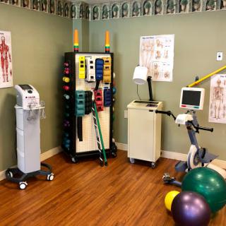A well-equipped physical therapy room featuring various exercise tools and rehabilitation equipment.