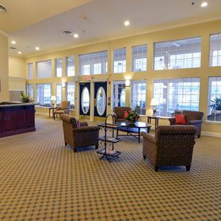 Spacious lobby with seating and large windows.
