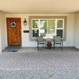 A welcoming front porch with seating and a decorative wreath.