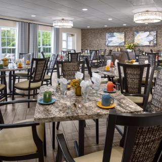A well-appointed dining area with elegantly set tables and comfortable seating.