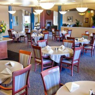 An elegantly decorated restaurant dining area with neatly arranged tables and chairs.