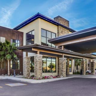 A modern hotel building with a stylish entrance and stone accents.