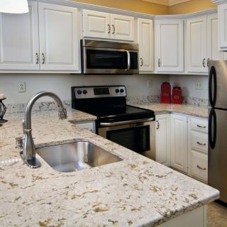 Modern kitchen with granite countertops and stainless steel appliances.