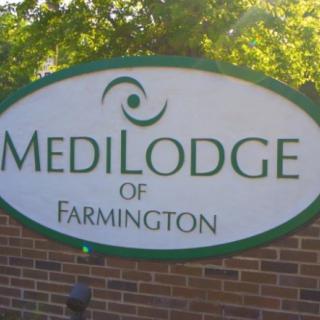 Sign for MediLodge of Farmington, a healthcare facility.