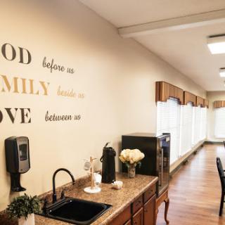 A cozy kitchen space adorned with inspirational wall art emphasizing the importance of God, family, and love.