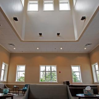 A spacious waiting room with comfortable seating and large windows providing natural light.