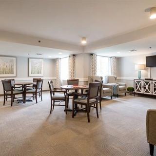 A well-decorated lounge area with tables, chairs, and comfortable seating.