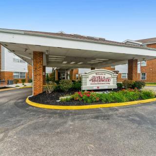 Entrance of a facility with a drive-through area and signage.