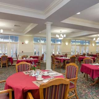 An inviting dining area with neatly arranged tables and chairs, set for a meal.