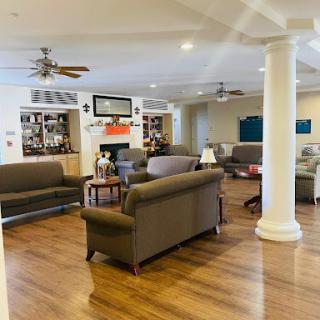 A spacious and inviting living room featuring comfortable seating and a warm ambiance.