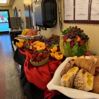A vibrant display of fruits and desserts arranged for an event.