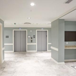 A modern hospital elevator lobby with bright lighting and clean design.