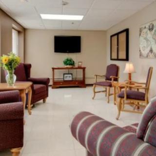 A cozy waiting room with comfortable seating and a television.