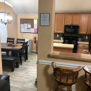 A cozy kitchen and dining area with wooden furniture and warm lighting.