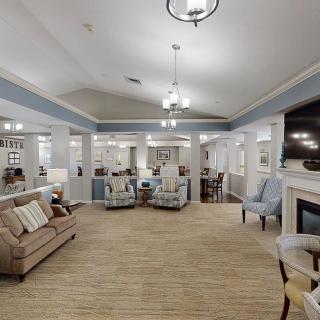 A cozy and elegantly furnished living room with a fireplace and comfortable seating.