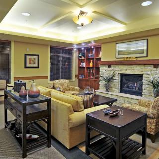 A cozy living room featuring a fireplace, plush seating, and elegant decor.