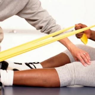 A physical therapy session involving resistance band exercises.