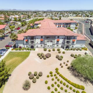 Aerial view of a suburban building with desert landscaping.
