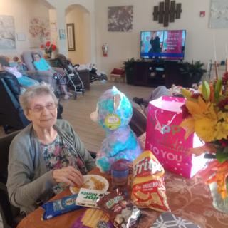 A joyful moment shared with snacks and gifts in a cozy indoor setting.