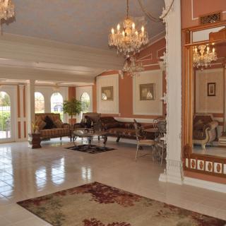 A luxurious lobby featuring chandeliers and elegant furniture.