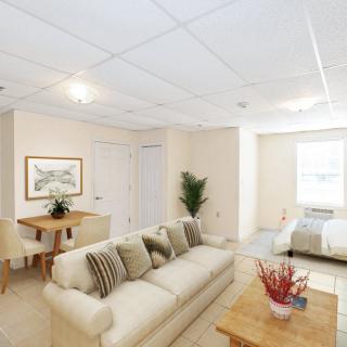 A bright and cozy open-plan living and dining area with neutral decor.