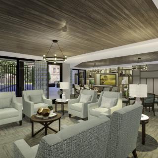 A modern living room featuring elegant furniture and a stylish chandelier.