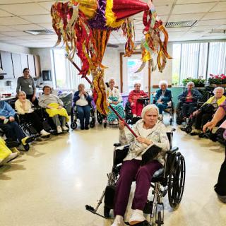Residents gather for a joyful celebration, participating in activities and enjoying the festive atmosphere.
