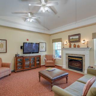 A cozy living room featuring comfortable seating, a fireplace, and modern amenities.