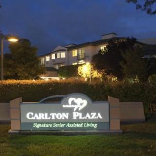 A nighttime view of Carlton Plaza, a signature senior assisted living facility.