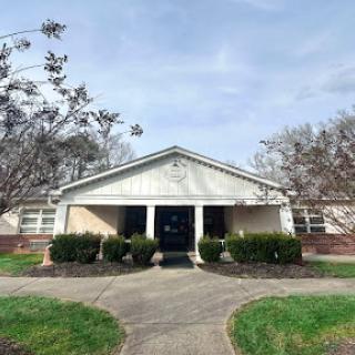 A welcoming community center with well-maintained landscaping and a clear entrance.