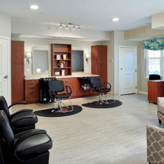 A modern hair salon featuring barber chairs, mirrors, and a welcoming waiting area.