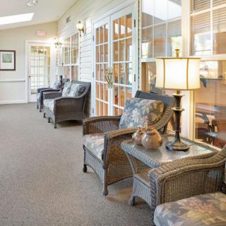 A cozy lobby with wicker furniture and warm lighting.