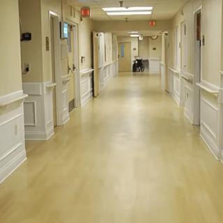 A quiet hospital hallway with doors on either side.